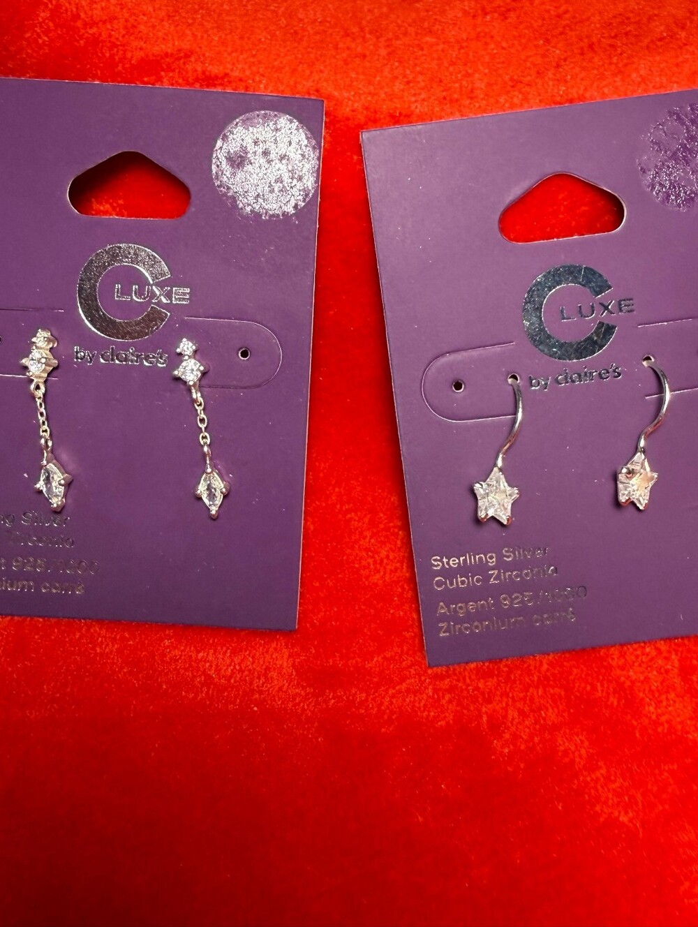 Claire's Silver Star Dangle Earrings on Purple Card